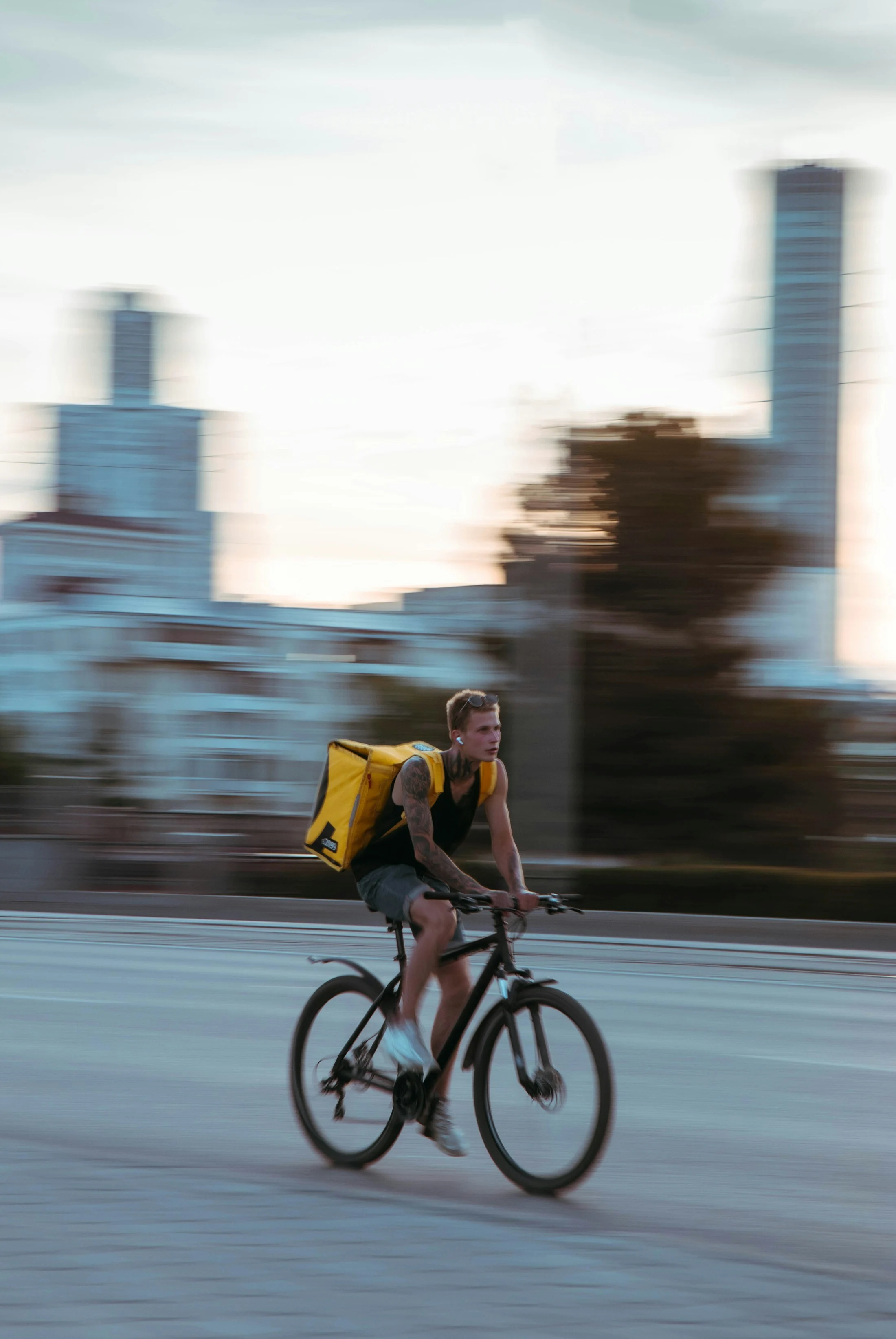 A bicycle courier travelling along a city street