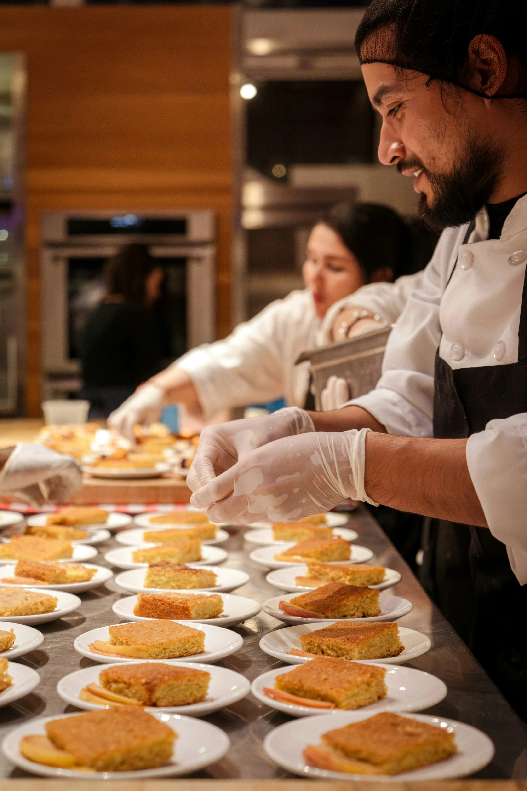 Restaurant staff carefully preparing meals in a professional kitchen