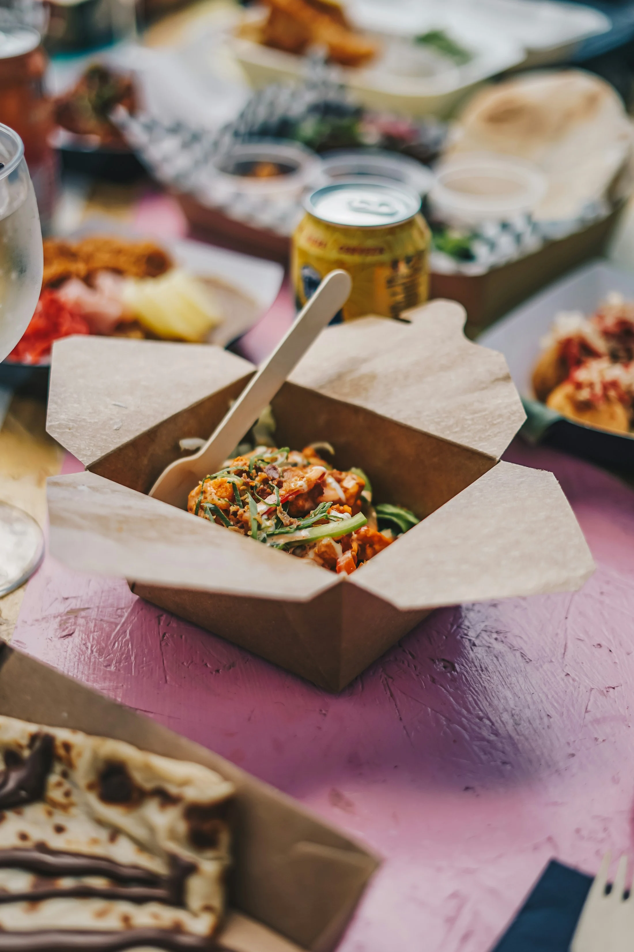 A freshly prepared meal in a kraft takeaway box