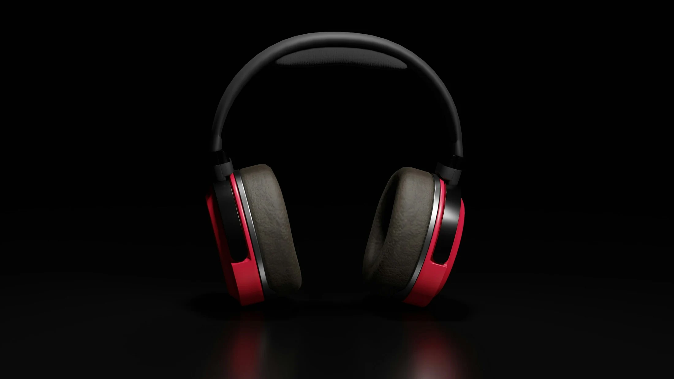 Over-ear headphones with red accents photographed against a black background