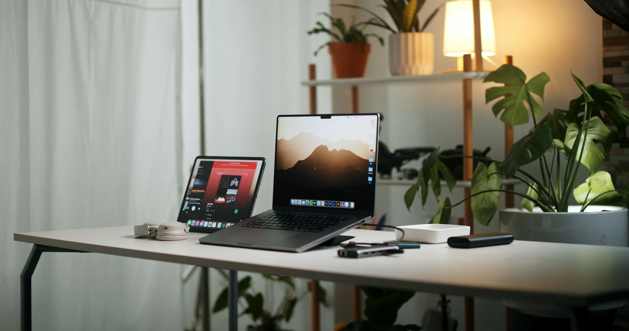 Laptop and tablet in a softly lit home workspace
